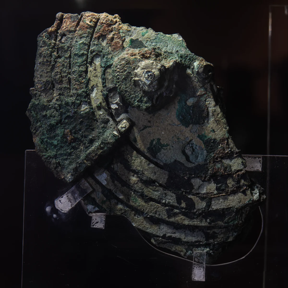 Fragment B: corroded bronze with part of a scale and a gear shaft