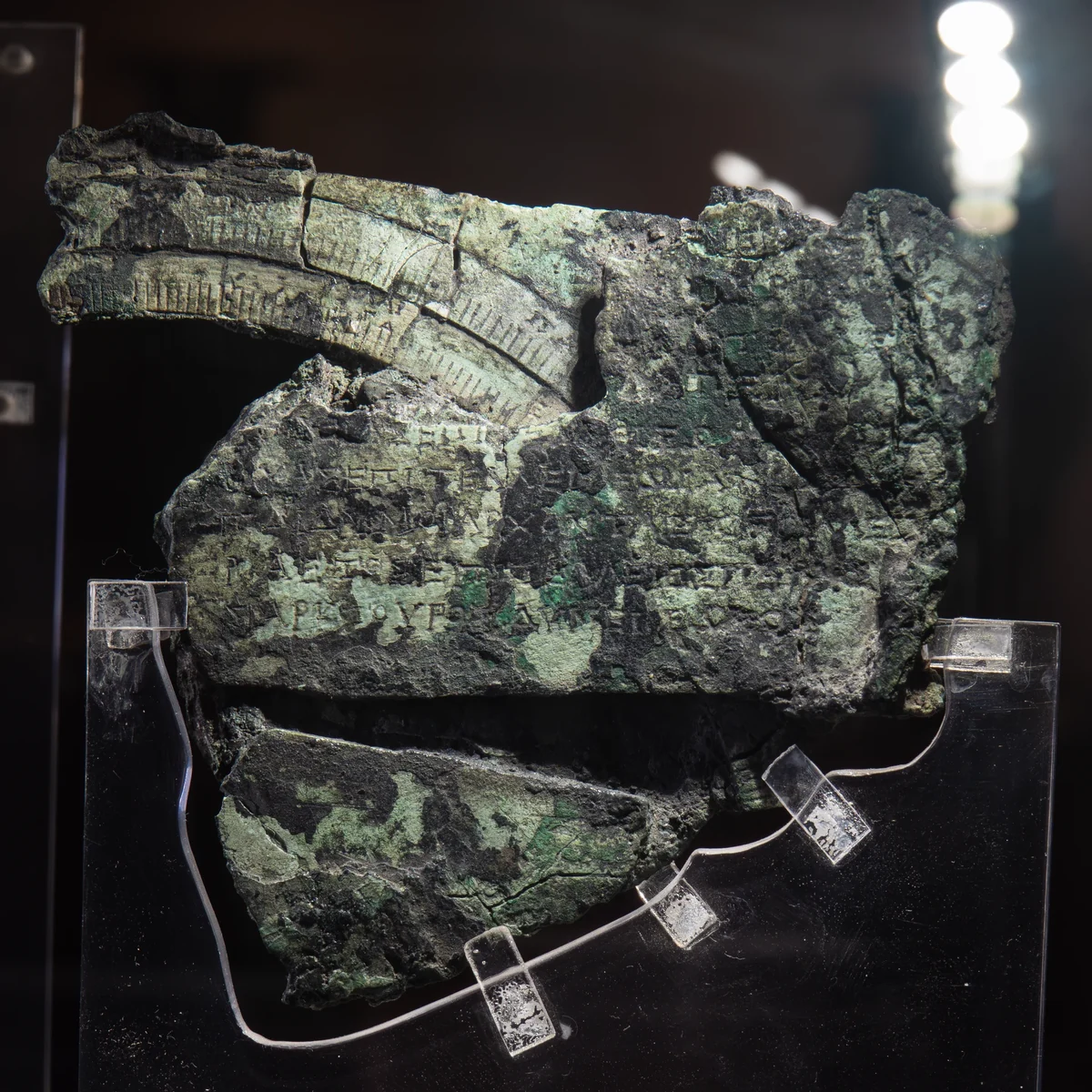 Fragment C: corroded bronze with parts of two circular scales